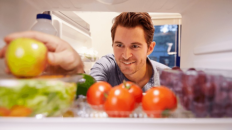 man-arranging-food-in-fridge-1